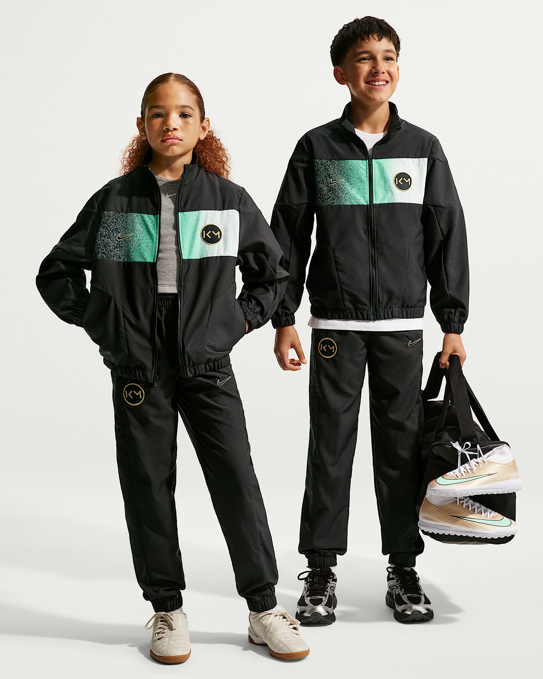 NIKE KM K TRACKSUIT WVN FZ BLACK/METALLIC GOLD